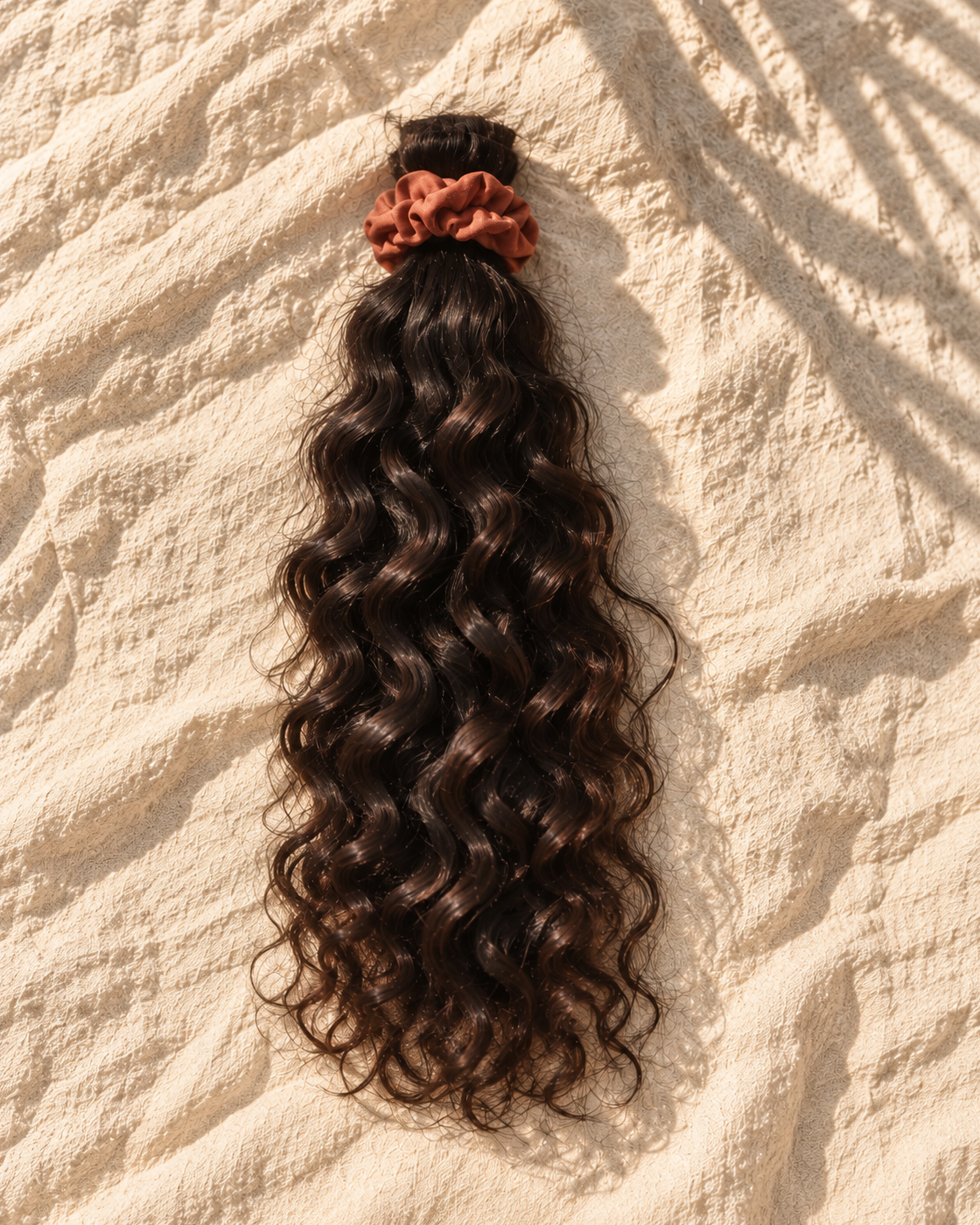 Deep Wave hair bundle on natural linen